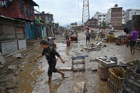 cleaning mud Myanmar|Residents of Myanmar capital clean up after floods leave.